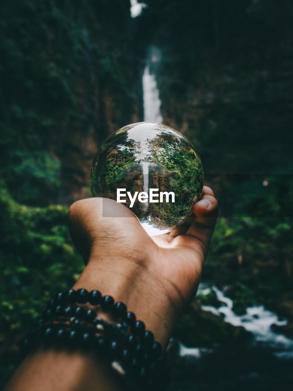 Close-up of hand holding crystal ball