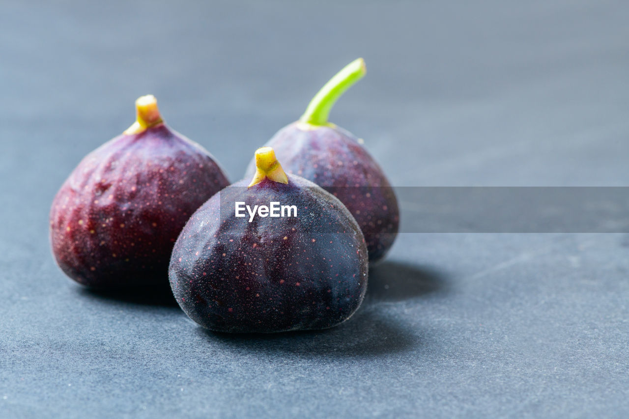 Fresh purple fig fruit on black table background,