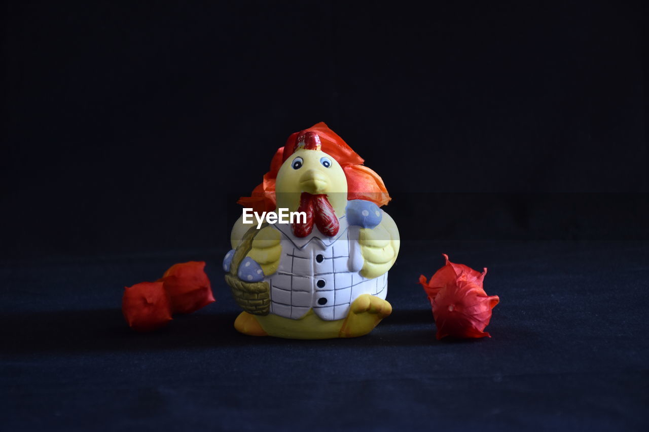 Close-up of a porcelain figurine with the title of flower supplier