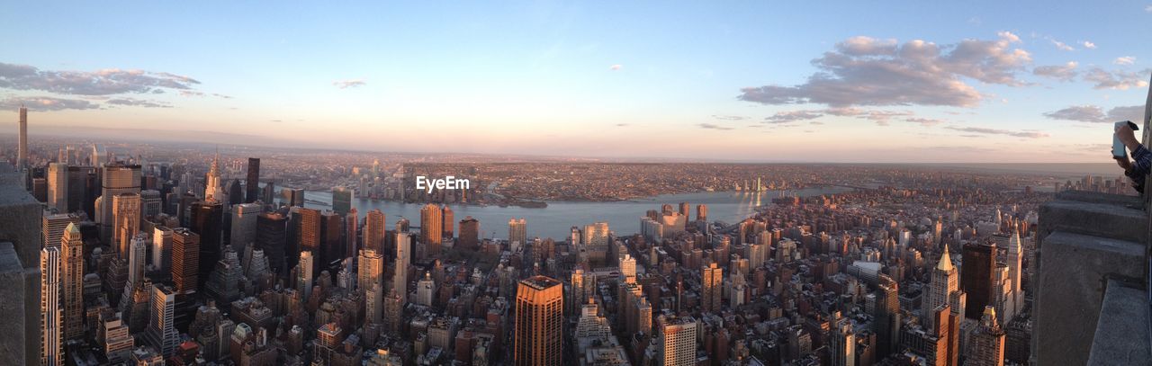 Panoramic view of cityscape against sky during sunset