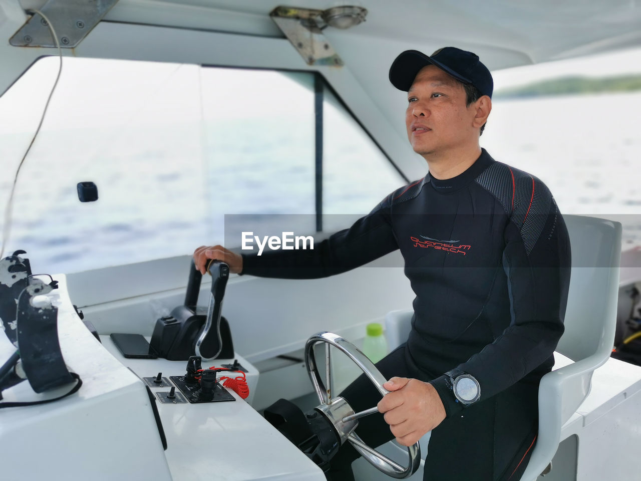 Side view of me sitting in the boat driving to a dive site destination