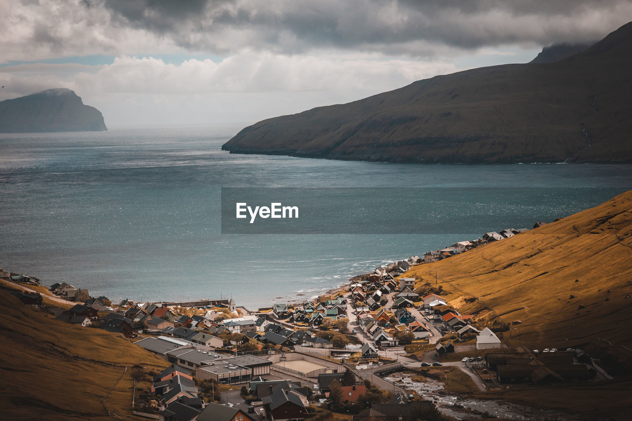 High angle view of houses by sea in town