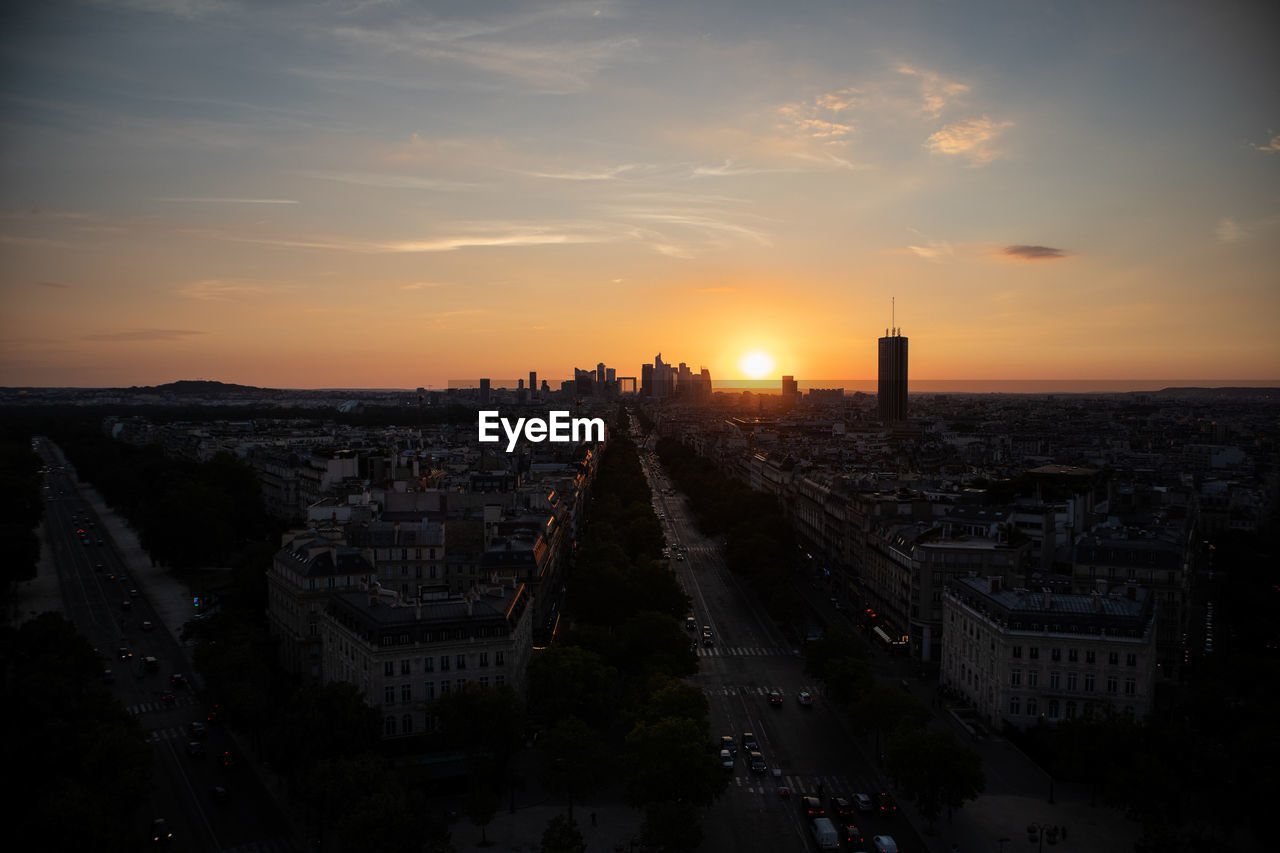 High angle view of buildings in city during sunset