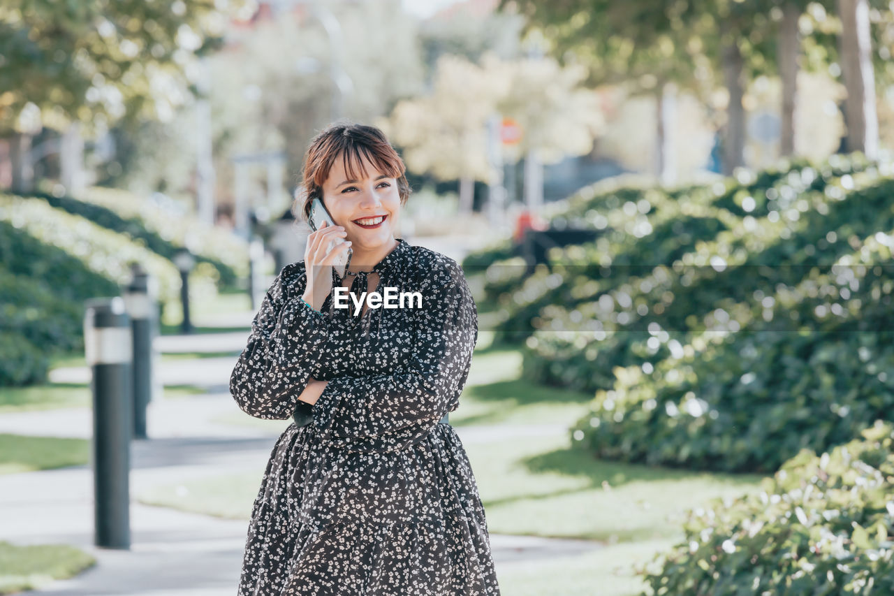 portrait of woman standing against plants