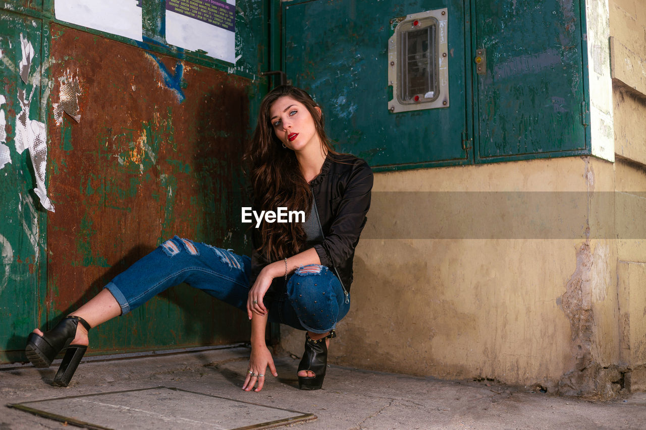 Beautiful woman posing on street photoshoot. young woman wearing casual clothing. 