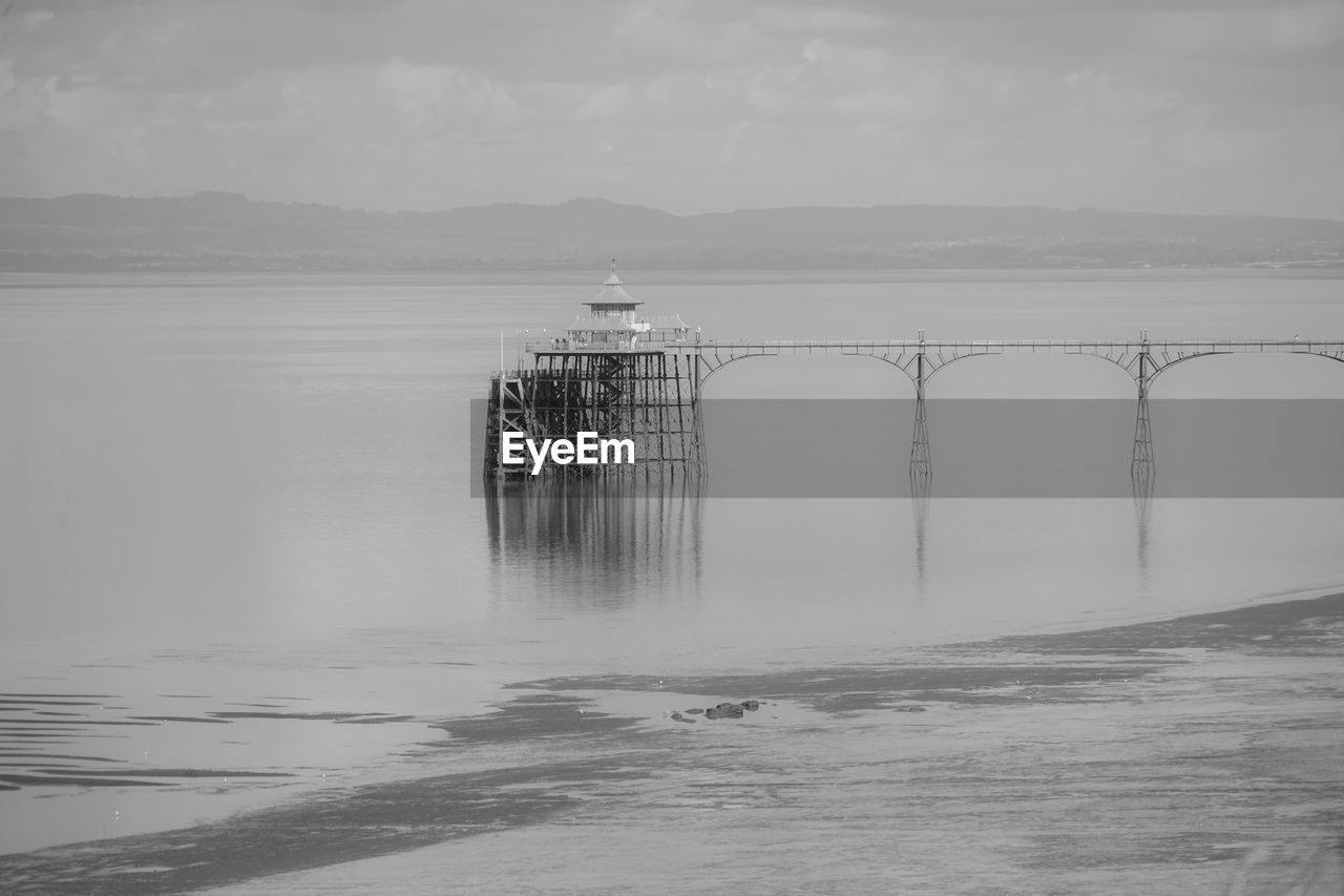 Panoramic photo of clevedon pier in somerset showing iron structure against blue sky