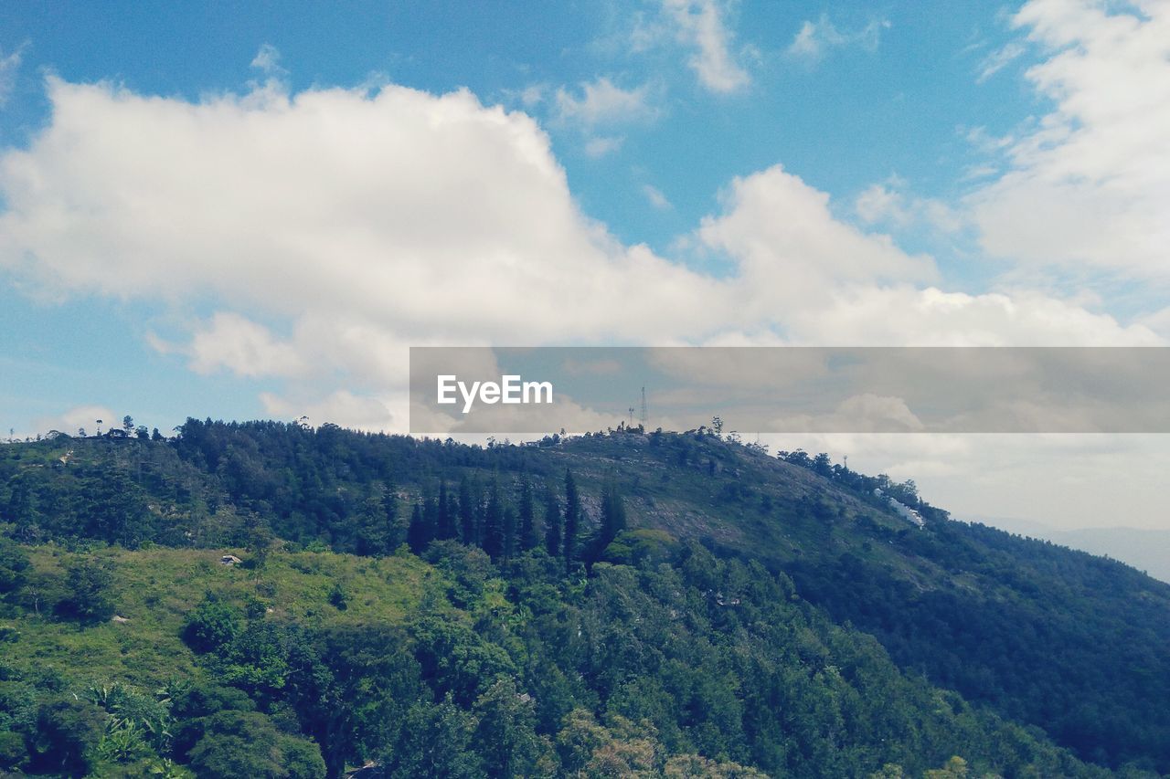 Scenic view of mountains against cloudy sky