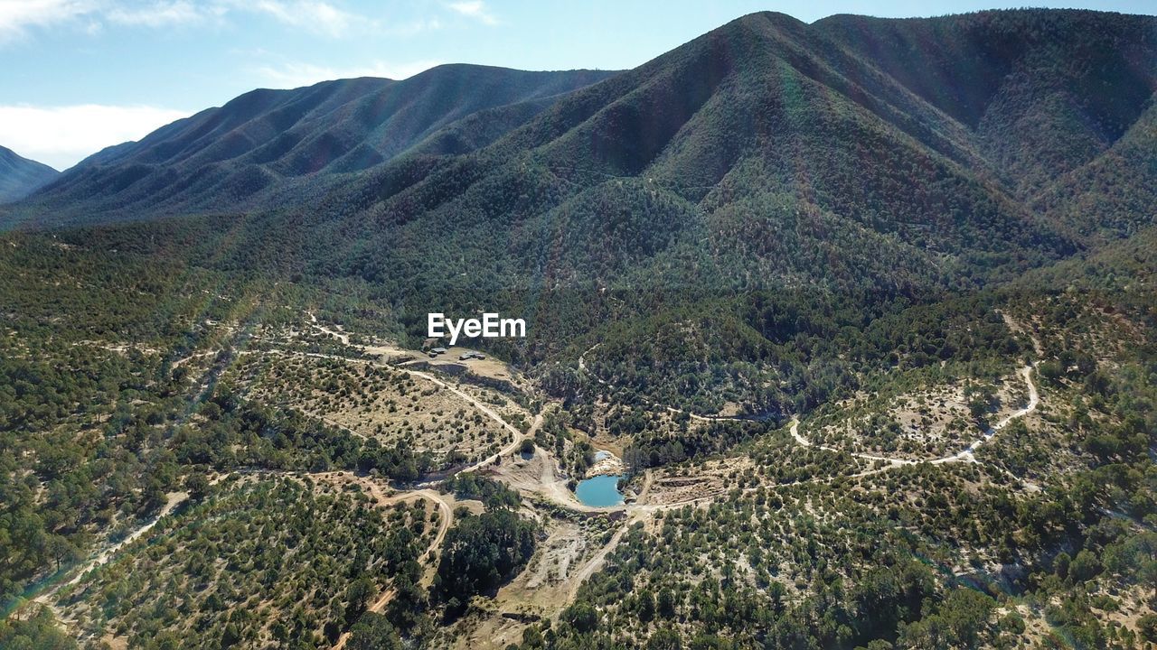 High angle view of land and mountains against sky