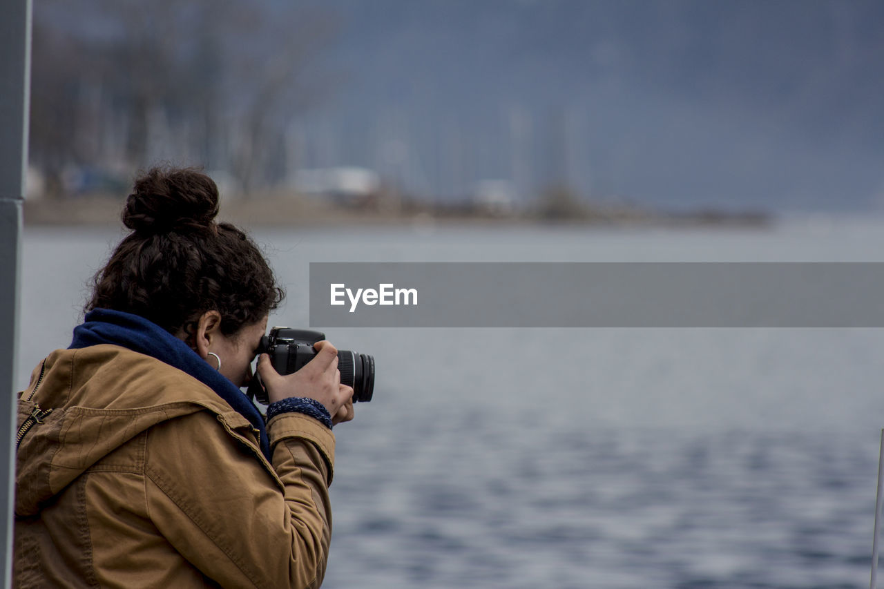 Woman photographing sea