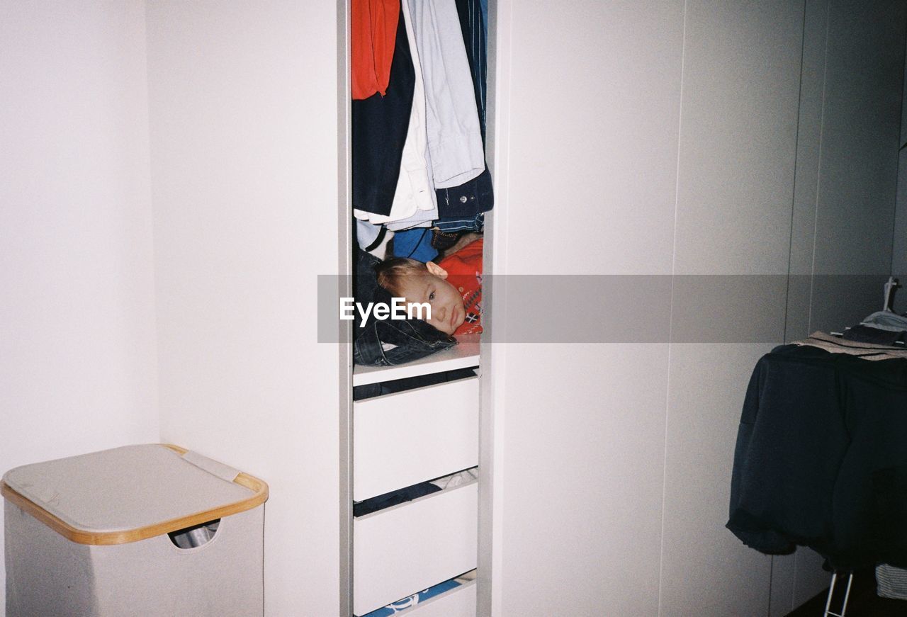 rear view of woman standing in cabinet