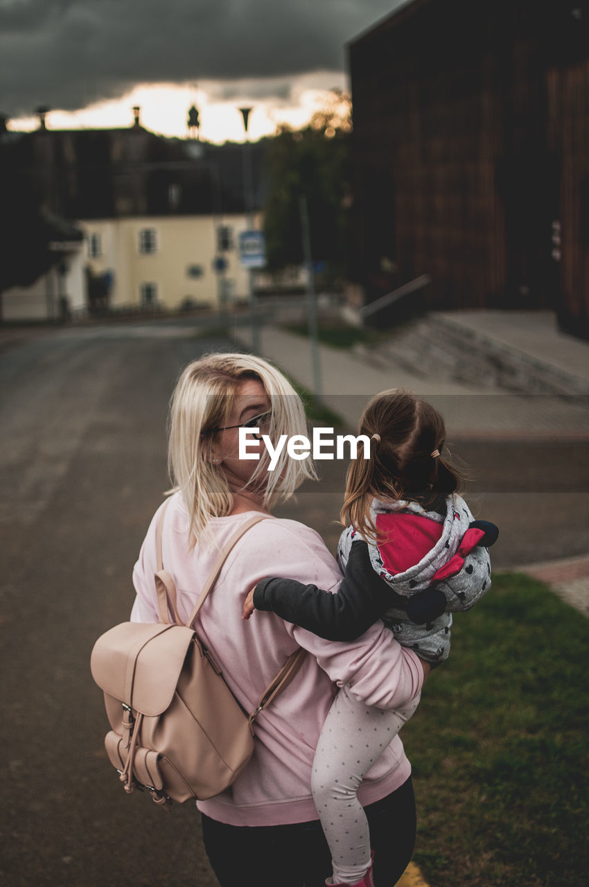 Girl standing on street in city