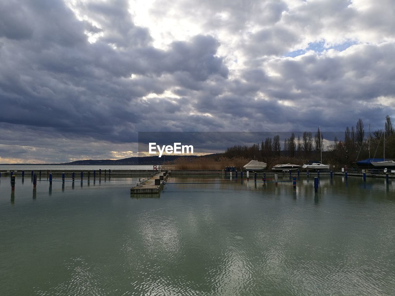 VIEW OF BRIDGE OVER RIVER AGAINST CLOUDY SKY