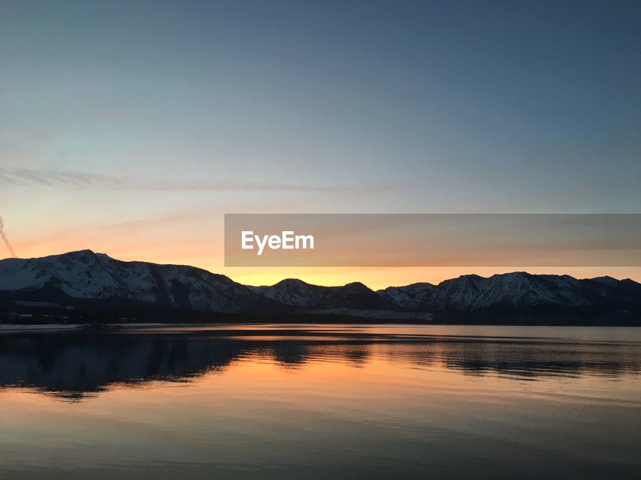 Scenic view of lake against sky during sunset