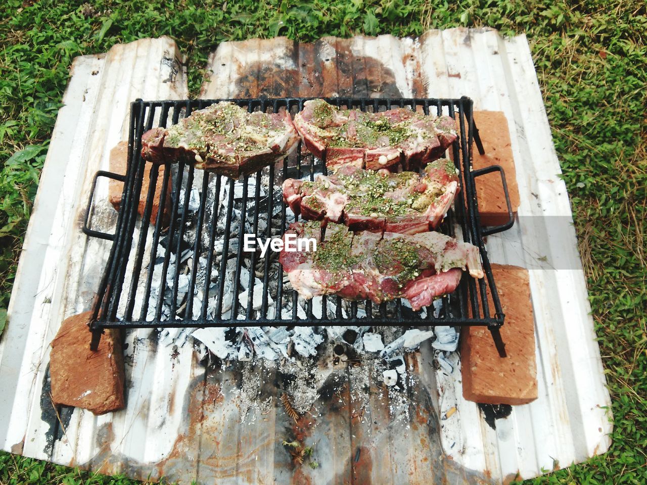 High angle view of meat on barbecue grill