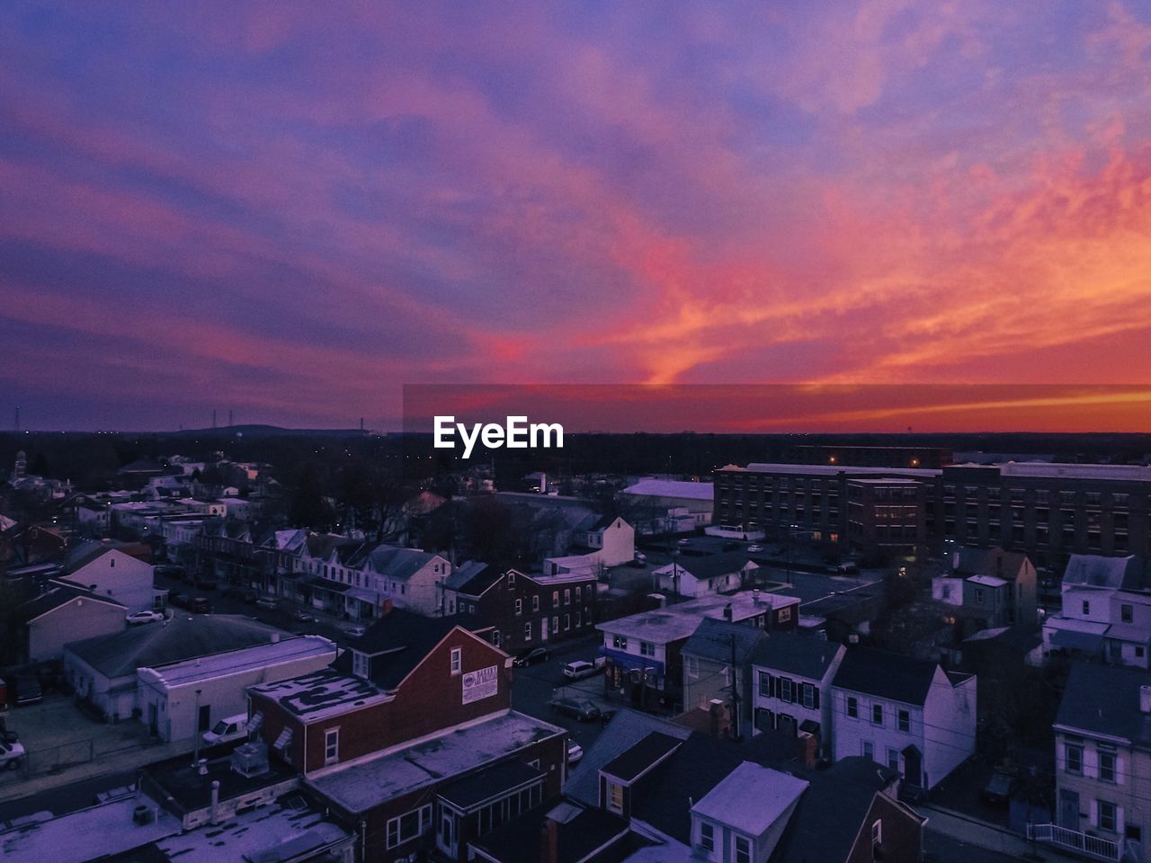 High angle view of town against sky at sunset