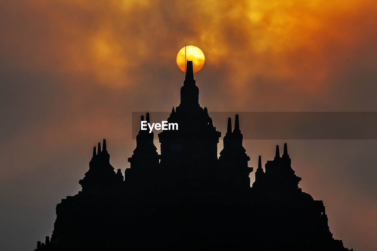 SILHOUETTE OF TEMPLE AGAINST SKY DURING SUNSET