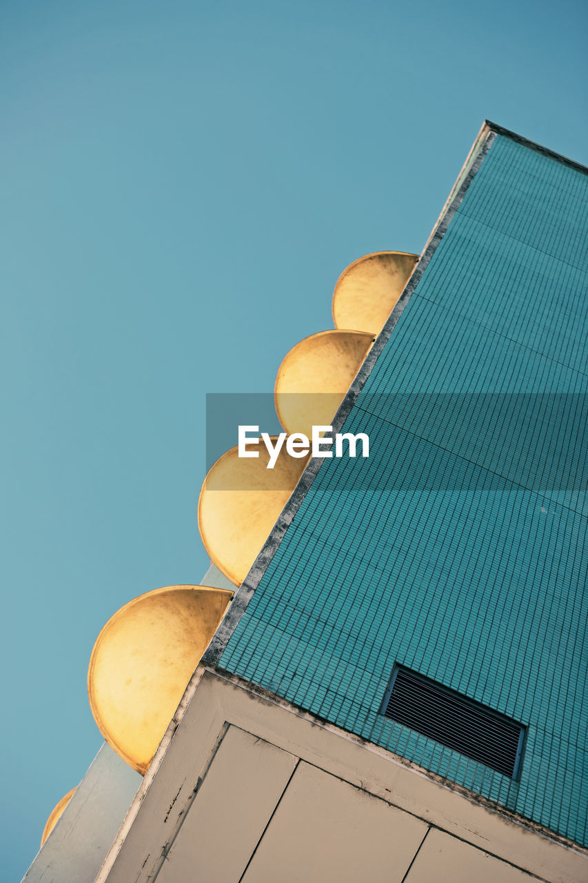 Low angle view of building against clear blue sky