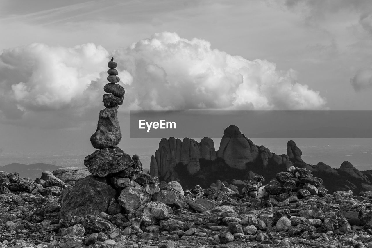 STACK OF ROCKS ON SHORE AGAINST SKY