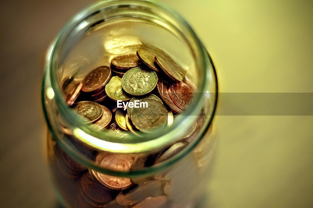 High angle view of coins in jar