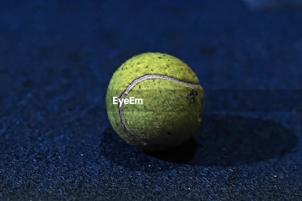 Close-up of tennis ball on playing field