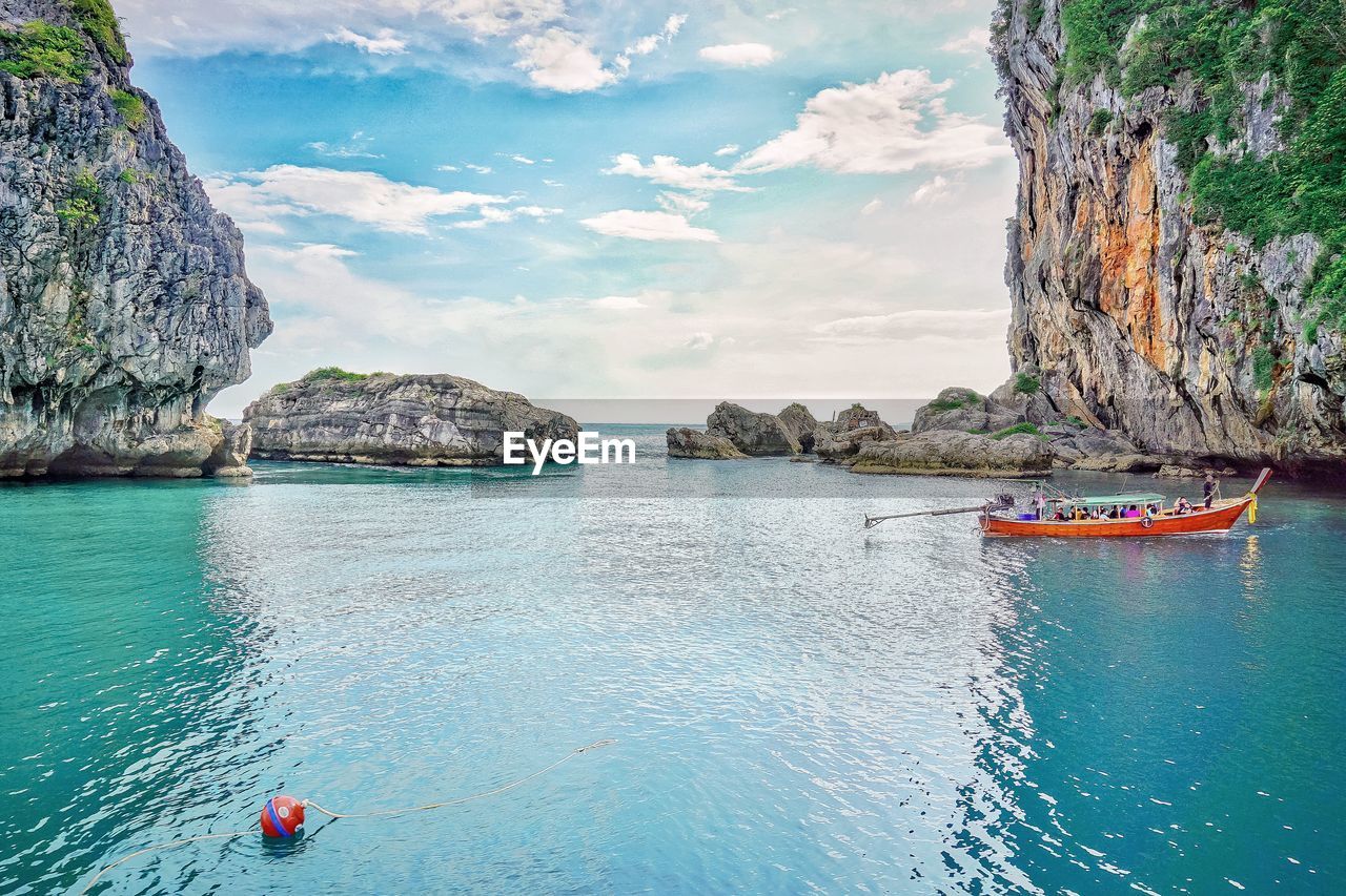 SCENIC VIEW OF SEA AGAINST ROCK FORMATION