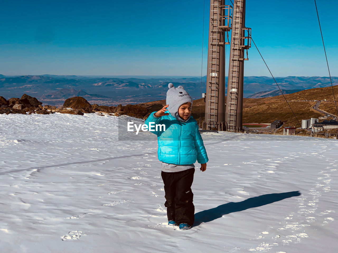 Little boy in the snow of the mountains of sierra nevada