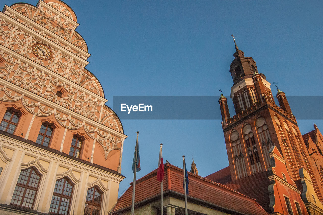 Low angle view of clock tower against blue sky