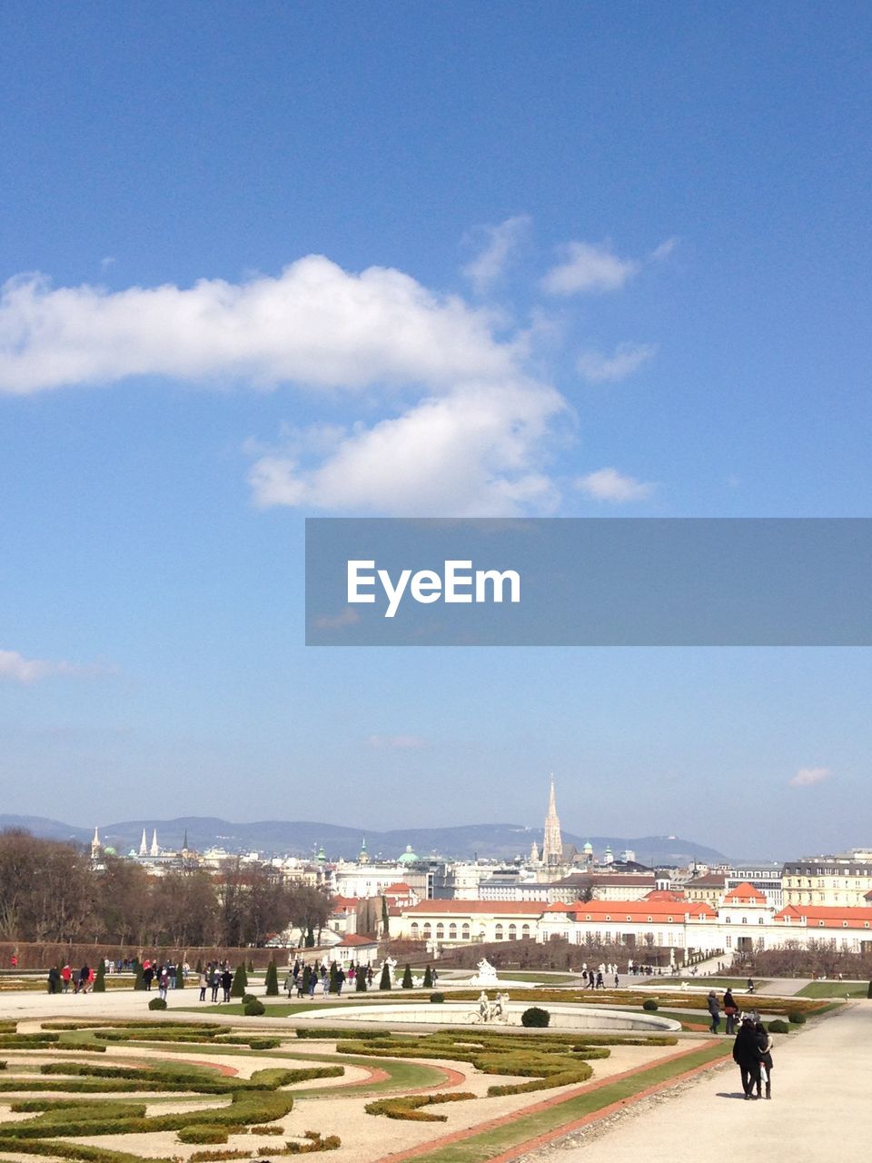 Buildings in city against cloudy sky