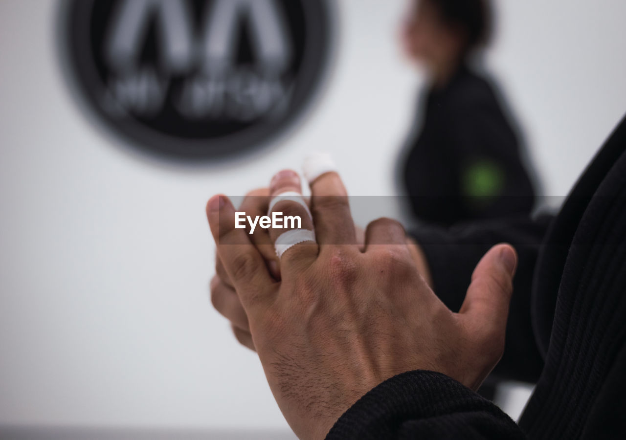 CLOSE-UP OF PERSON HAND ON BLACK BACKGROUND