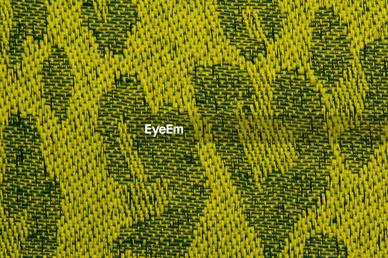 FULL FRAME SHOT OF YELLOW PATTERN ON FABRIC