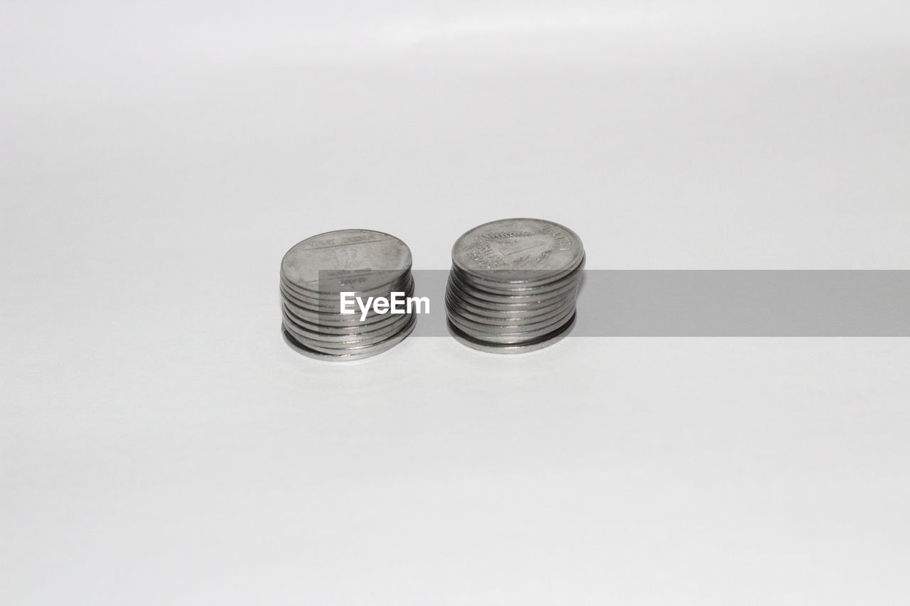 HIGH ANGLE VIEW OF COIN ON TABLE