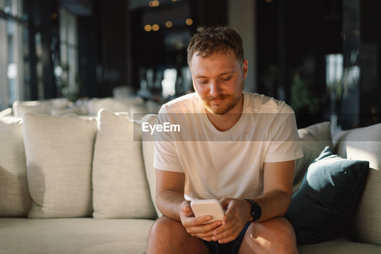 portrait of man sitting on sofa at home