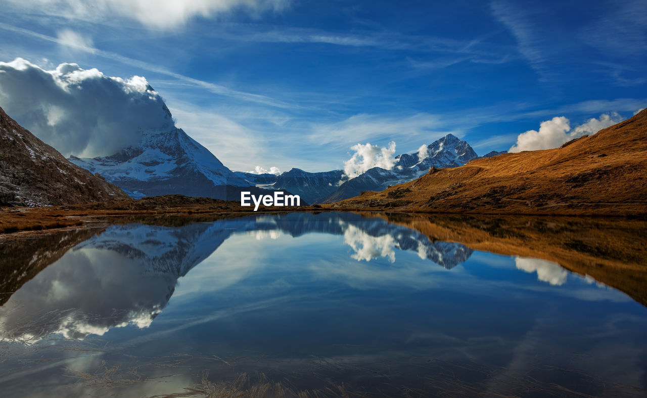 Scenic view of lake and mountains against sky