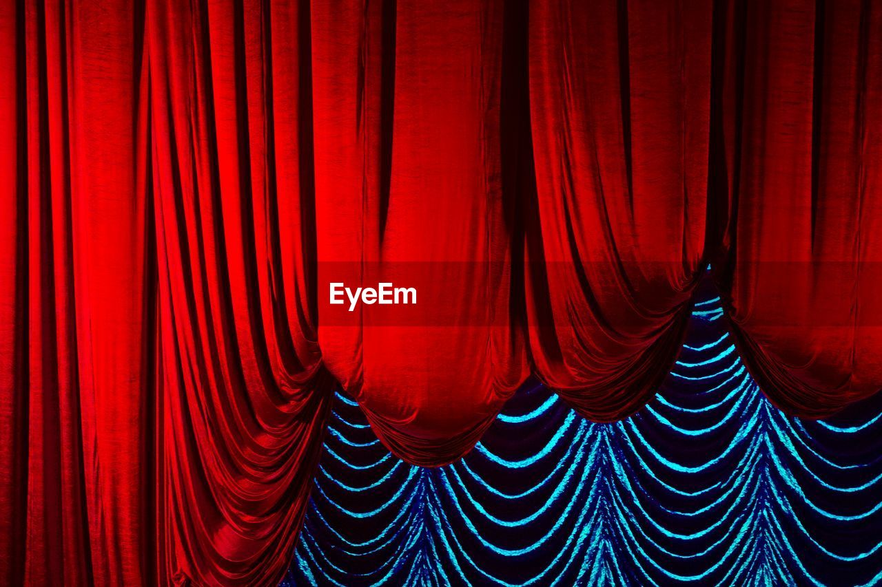 Close-up of red curtains at auditorium