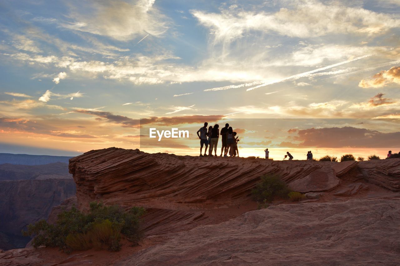 People standing on rocky landscape