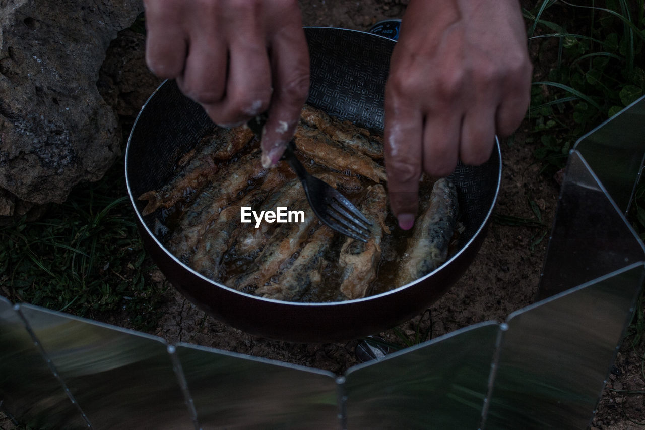 Cropped hand of man preparing food