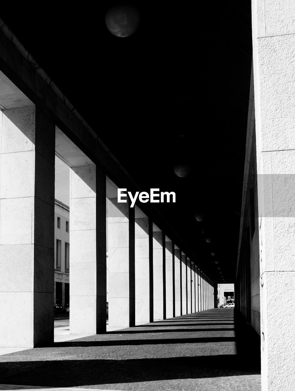 Sunlight falling on empty corridor of building