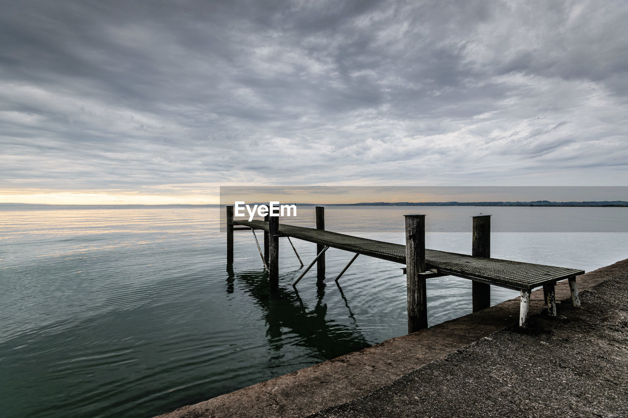 water, sky, horizon, sea, cloud, ocean, shore, scenics - nature, nature, beauty in nature, coast, tranquility, beach, land, tranquil scene, wood, pier, environment, landscape, horizon over water, seascape, no people, morning, wave, architecture, reflection, jetty, outdoors, dusk, dramatic sky, travel destinations, idyllic, sunlight, summer, coastline, non-urban scene, travel, bay, holiday, relaxation, built structure, cloudscape, day, railing, trip, sunrise, vacation, urban skyline