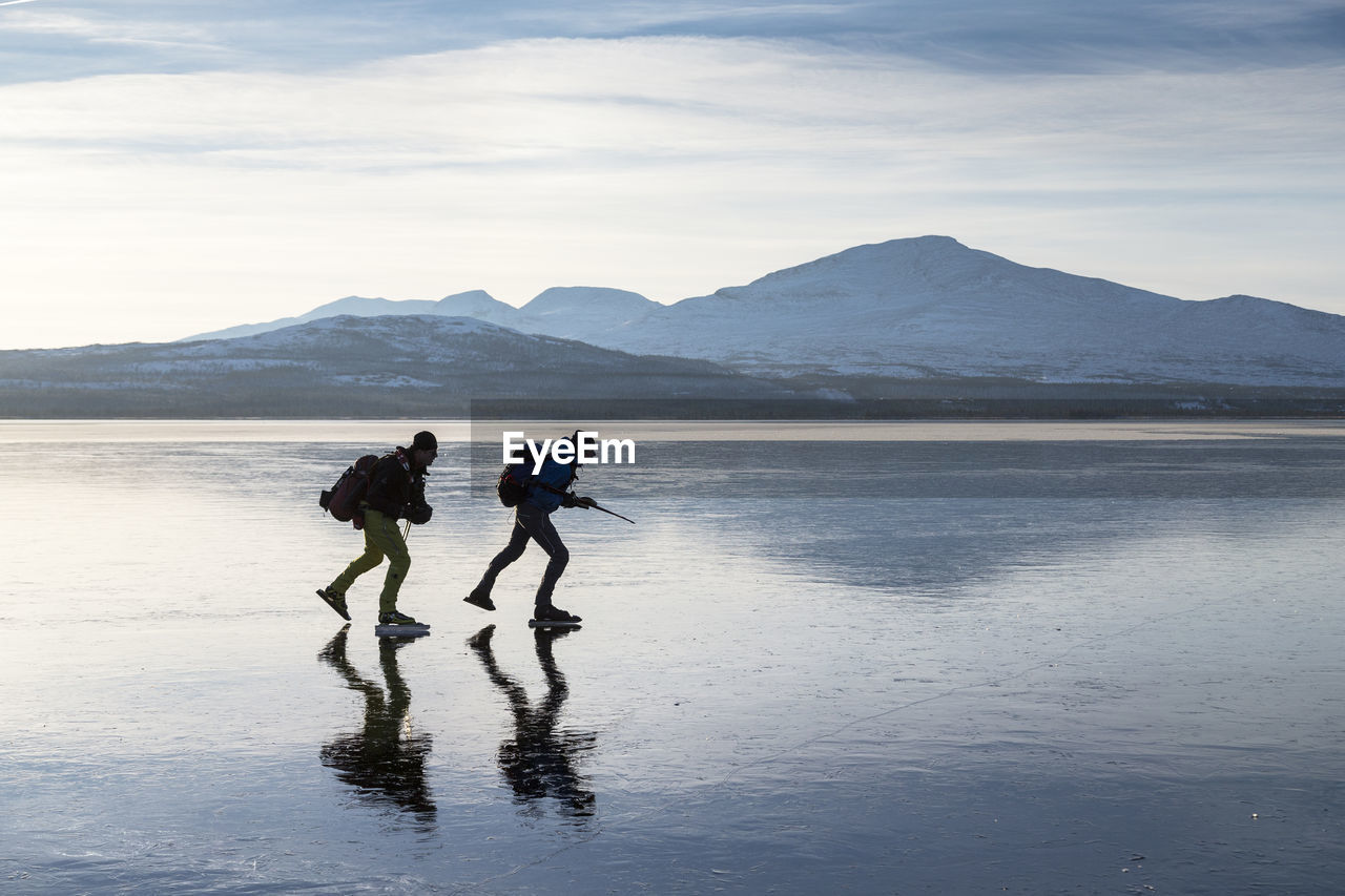 Two people moving on ice