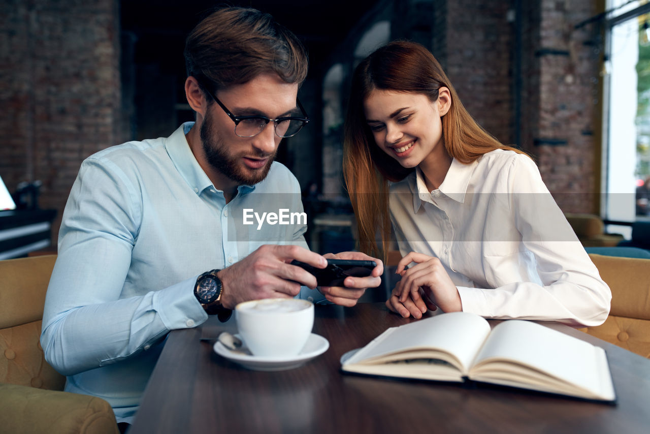 Young couple holding smart phone