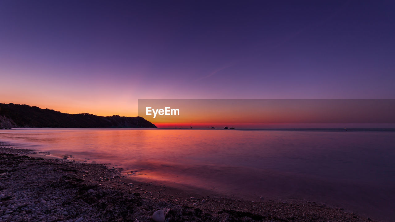 SCENIC VIEW OF SEA AGAINST ROMANTIC SKY