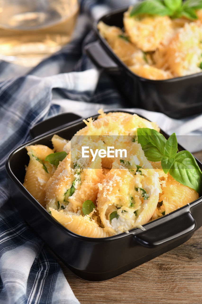 Pasta conchiglioni stuffed with spinach, ricotta and parmesan baked