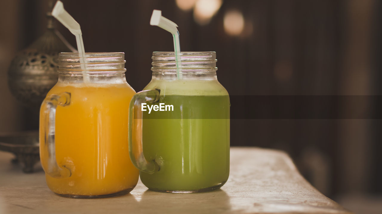 Close-up of juice in jars on table