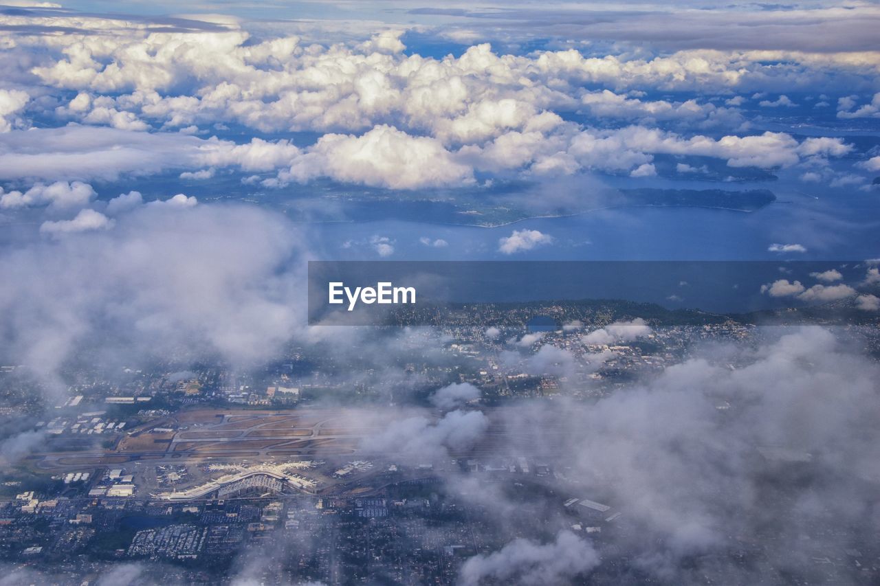 Seattle oregon aerial views from airplane. cloud cover, sea ocean and city views.