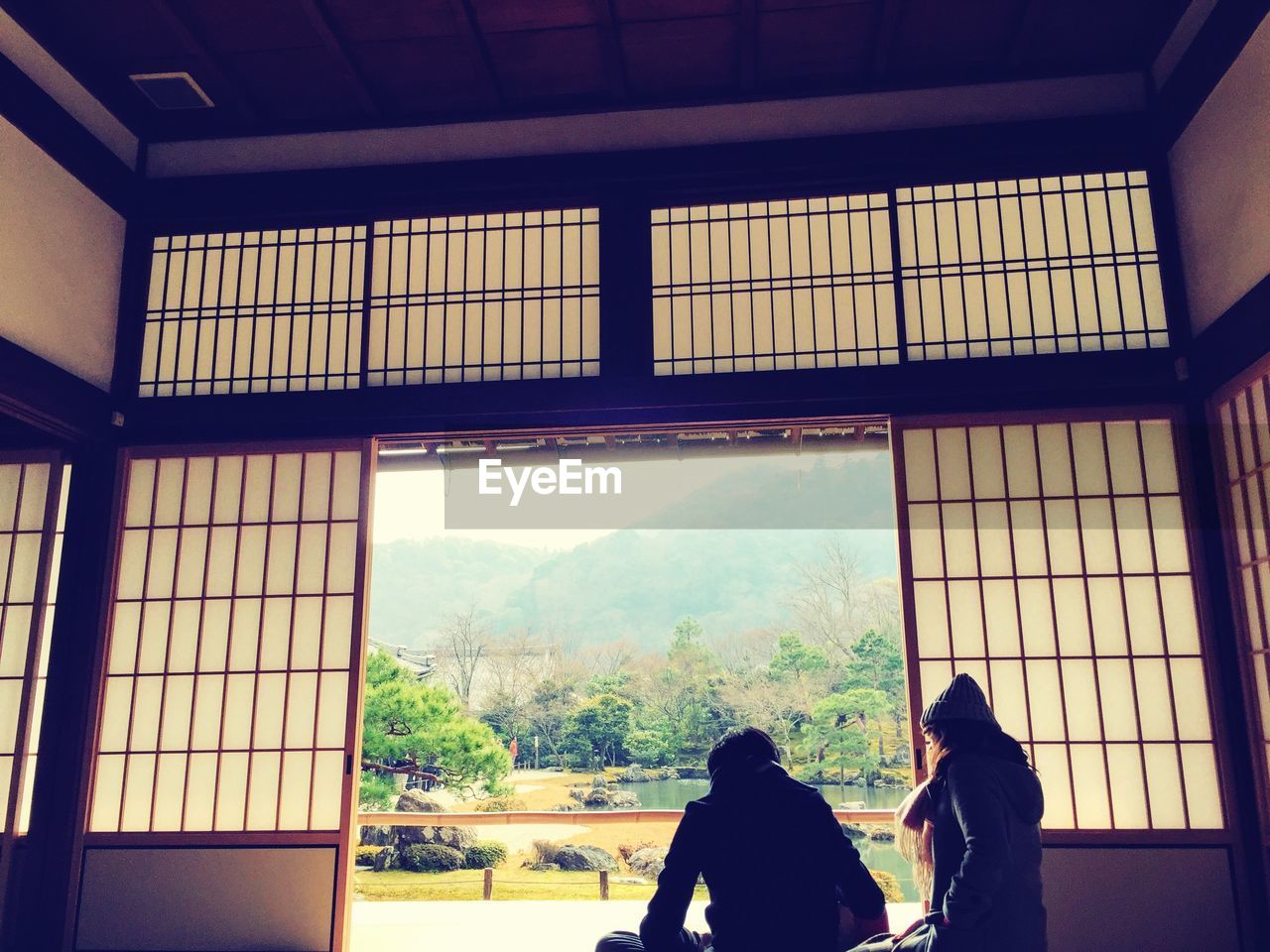 Couple standing by window