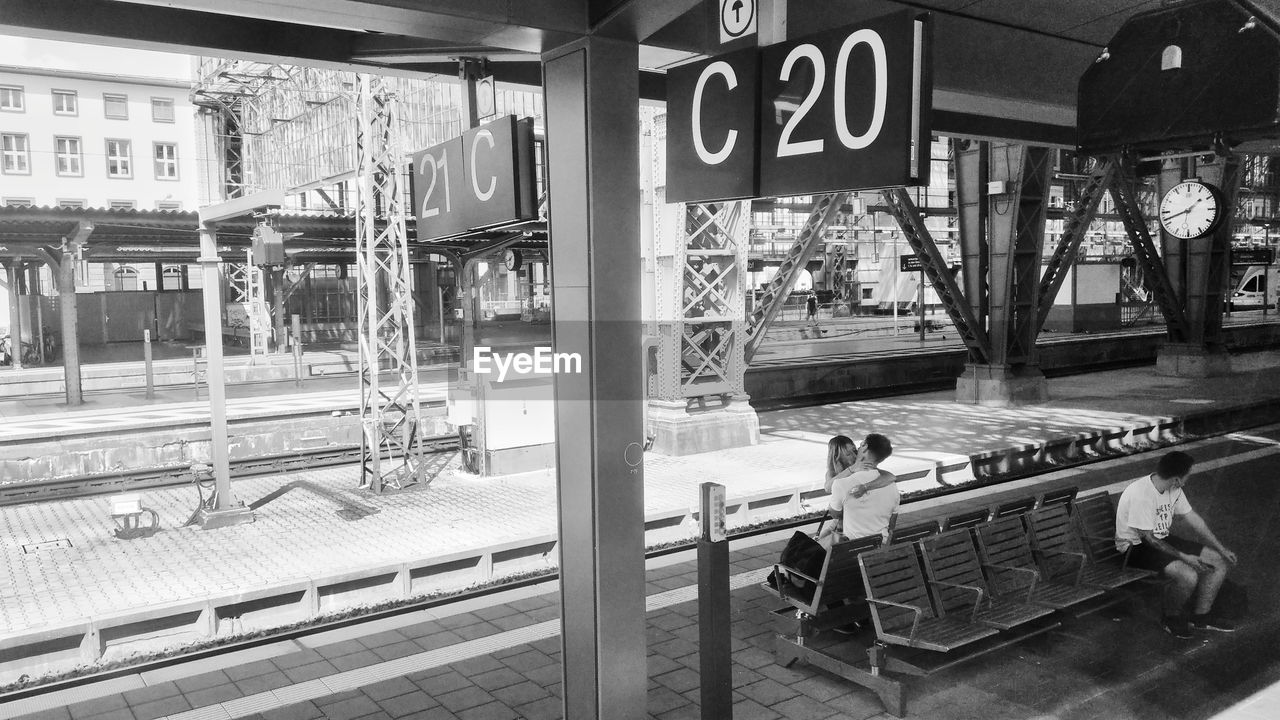 MAN WAITING AT RAILROAD STATION