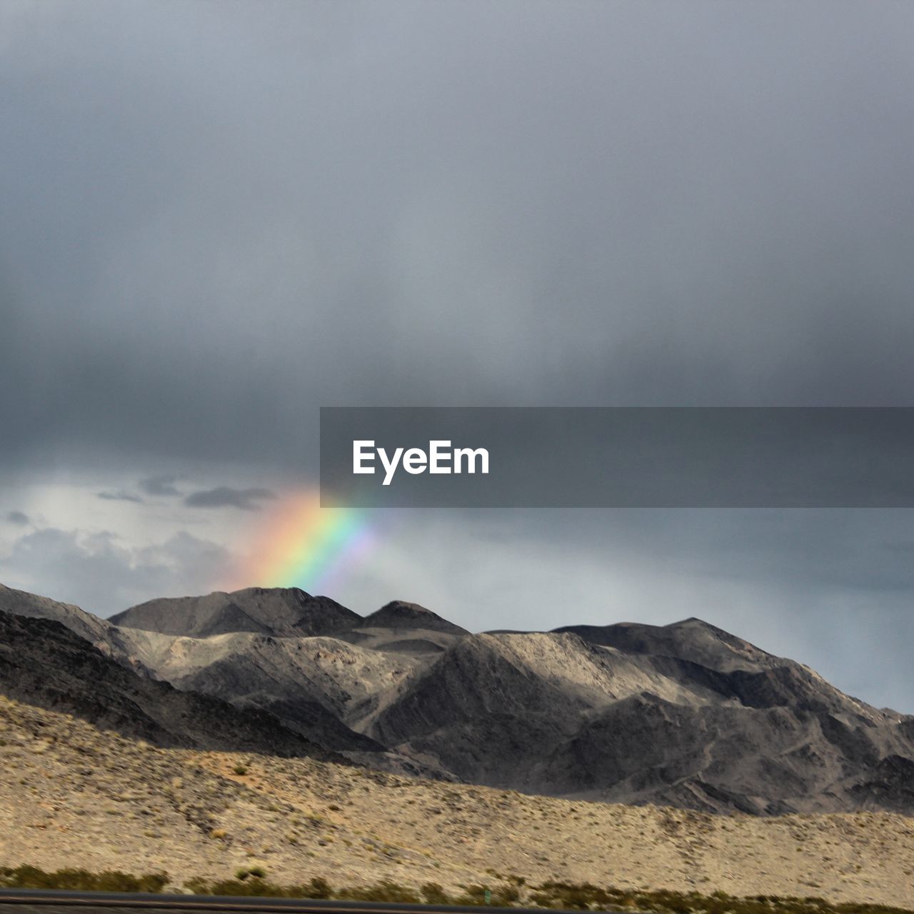 Scenic view of mountains against rainbow