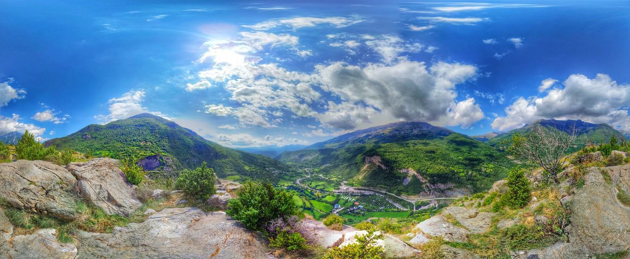 Scenic view of mountain range against blue sky