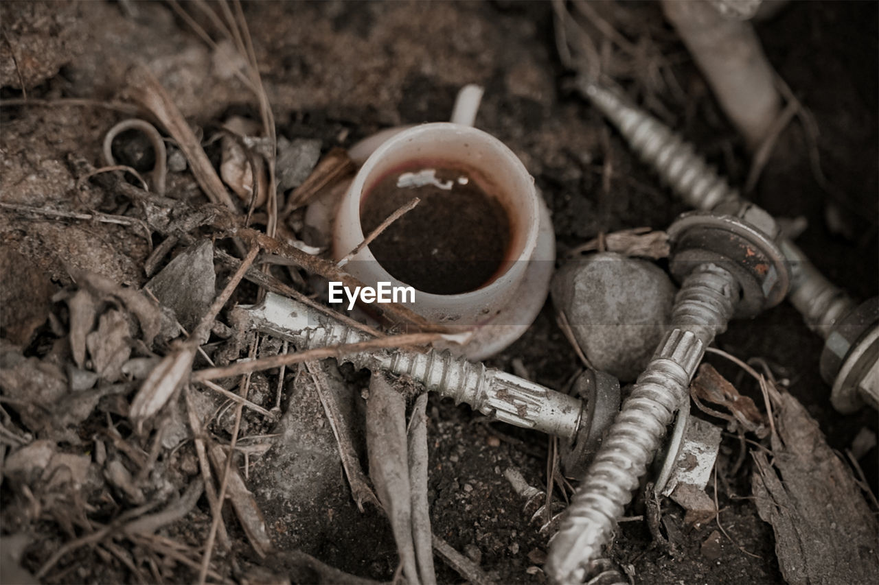 HIGH ANGLE VIEW OF OLD METAL ON FIELD