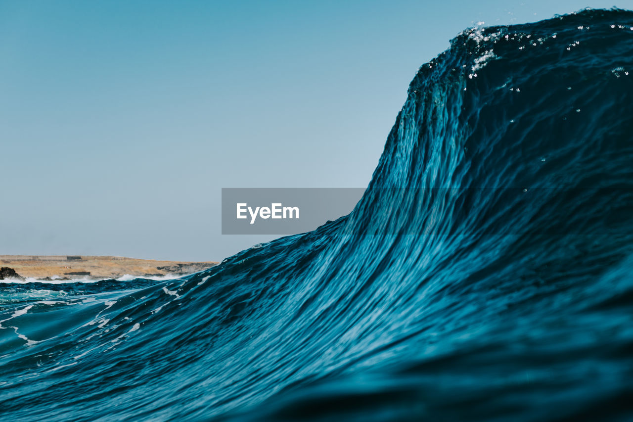 Close-up of sea against clear blue sky